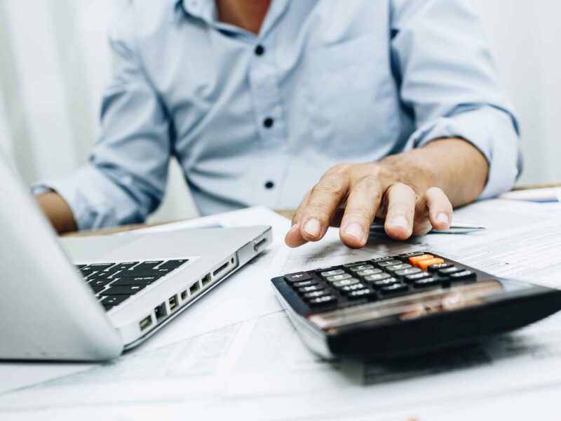 close up of tax accountant doing tax preparation at a desk