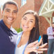 smiling couple holding the keys to their new rental