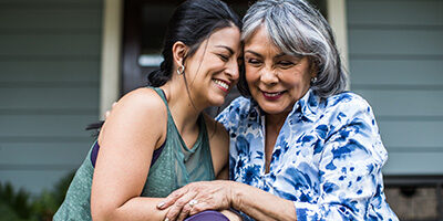 Two retired women hug as they discuss Required Minimum Distribution and what the CORRECT RETIREMENT PLAN DISTRIBUTION is.