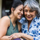 Two retired women hug as they discuss Required Minimum Distribution and what the CORRECT RETIREMENT PLAN DISTRIBUTION is.
