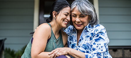 Two retired women hug as they discuss Required Minimum Distribution and what the CORRECT RETIREMENT PLAN DISTRIBUTION is.