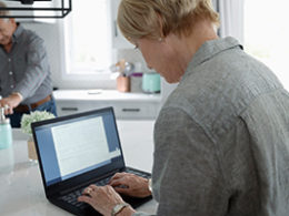 A woman sits in front of a laptop, as Nissen and Associates helps her clean up her QuickBooks account online