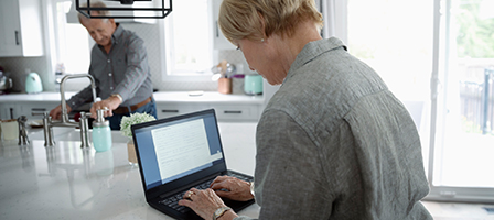 A woman sits in front of a laptop, as Nissen and Associates helps her clean up her QuickBooks account online