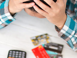 Man holding head in hands looking at Bad business credit score