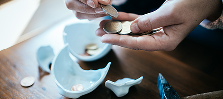 Can't pay your taxes? A hand is counting pennies as a person is going through FINANCIAL HARDSHIP