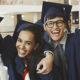 Three jovial students in graduation cap and gown. clutching their diplomas, celebrate the above The Line Education Tax Deduction Reinstatment