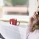 A woman looks a paper in her hand with an unhappy expression wondering What To Do If You Receive An IRS Deficiency Notice