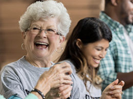 A elderly woman laughs as she talks to a friend about the New Twist Added To The IRA-To-Charity Provision