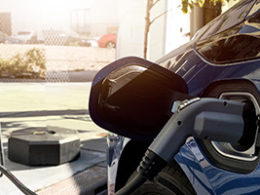 Congress Green-Lights Some Alternative Vehicle Credits, a car sits at the gas pump with a gas pump inserted into the gas tank