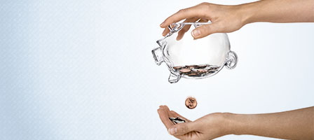 Can't Pay Your Taxes? Payment Due Date Extended Because Of Covid-19. One hand holds a piggy bank upside down dropping a single coin into the other hand.