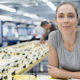 Congress Provides Sick Leave and Child Care Leave Benefits for Employees. A woman looks hopeful as she sits in her office chair on a manafacturing plant