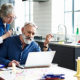 Did You Take Your 2020 RMD Too Soon? An elderly woman peers through her glasses, looking at a laptop screen, while her husband is typing.