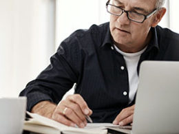 Did You Overlook Something on A Prior Tax Return? A man sits at his home office, overlooking his tax return