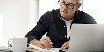 Did You Overlook Something on A Prior Tax Return? A man sits at his home office, overlooking his tax return