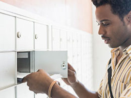 Watch Out: The Treasury Is Sending Some Stimulus Payments by Debit Card - a man looks for a document in his mail box