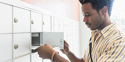 Watch Out: The Treasury Is Sending Some Stimulus Payments by Debit Card - a man looks for a document in his mail box