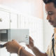 Watch Out: The Treasury Is Sending Some Stimulus Payments by Debit Card - a man looks for a document in his mail box