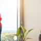 Wealthy Taxpayers May Want to Strategize for Potential Tax Increases, a woman stands by a window of a classy home looking out at the view.