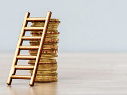 IRS Extends the Opportunity to Defer Capital Gains. A ladder leans against a stack of gold coins