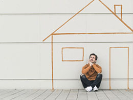 Unable to Keep Up with Your Home Mortgage Payments? A man sits on the ground outside a stick drawing of a house.