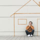 Unable to Keep Up with Your Home Mortgage Payments? A man sits on the ground outside a stick drawing of a house.