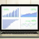 12 Financial Metrics Small Business Owners Should Track - a laptop is open showing positive metrics on spreadsheets with the lines all going up.