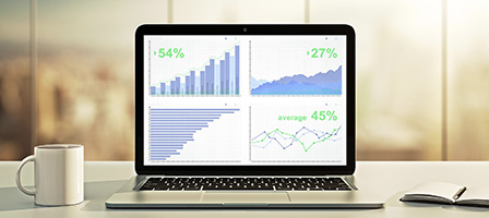 12 Financial Metrics Small Business Owners Should Track - a laptop is open showing positive metrics on spreadsheets with the lines all going up.