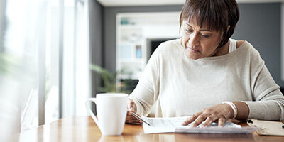 A woman looks over her tax return, checking out the full array of Tax Planning Opportunities