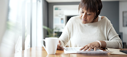 A woman looks over her tax return, checking out the full array of Tax Planning Opportunities