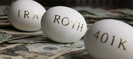 Saving For Retirement? Three golden eggs sit on a desk with IRA, ROTH and 401K written on them.