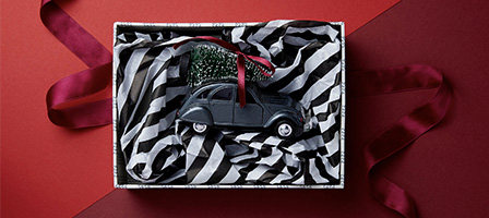 Year-End Gift Giving with Tax Benefits, an ornament sits inside a gift box lined with tissue paper.