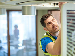 Your Annual Reminder to file worker form 1099-NEC, a worker in industrial clothing works on a doorframe