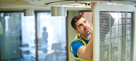 Your Annual Reminder to file worker form 1099-NEC, a worker in industrial clothing works on a doorframe