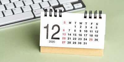 Tax Issues to Be Aware of as Year-End Approaches. A calendar sits out on a desk near a laptop