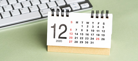 Tax Issues to Be Aware of as Year-End Approaches. A calendar sits out on a desk near a laptop