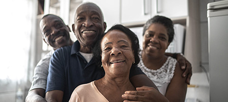 Video: Biden's COVID Relief & Tax Plan. A family of 4 stands together with smiles of gratitude.