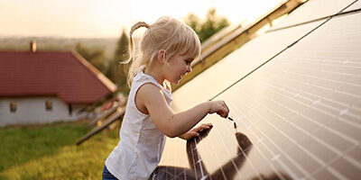 Solar Tax Credit Extended For Two Years, a young girl touches a solar panel