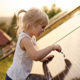 Solar Tax Credit Extended For Two Years, a young girl touches a solar panel