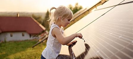 Solar Tax Credit Extended For Two Years, a young girl touches a solar panel