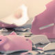Unemployment Fraudsters May Create A Tax Nightmare for Unsuspecting Taxpayers, A broken piggy bank lies smashed on a table with a few coins scattered about.
