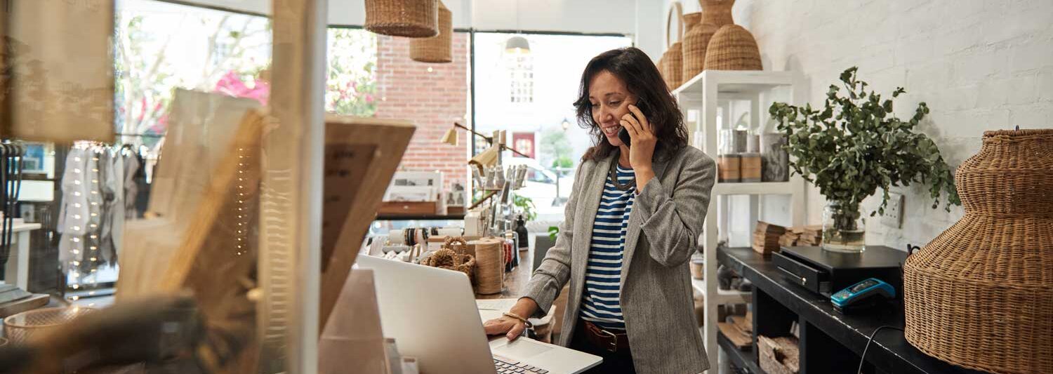 Bellingham Tax and Accounting is here to help. A small business owner stands in a retail gallery with sunlight streaming in.