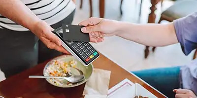 Customer paying for a meal with a card using a portable payment terminal wondering if there will be a Tax Deduction for Tips