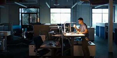 A man works late in an office at Nissen and Associates deciphering the new Deduction for Overtime under the One Big Beautiful Bill Act.